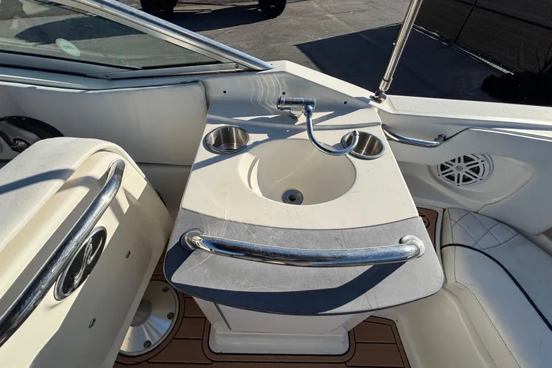 Slide: The Image of 2007 Sea Ray SLX 250 boat with white interior and windshield, parked outdoors. - 20