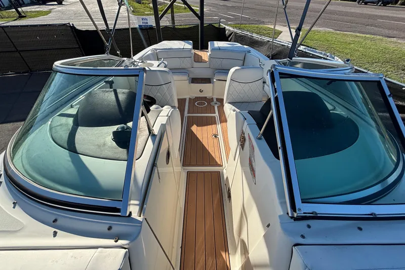 Slide: The Image of 2007 Sea Ray SLX 250 boat deck with teak flooring and white seating. - 24