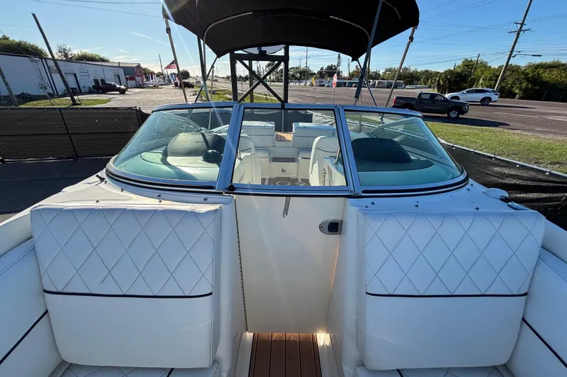 Slide: The Image of 2007 Sea Ray SLX 250 boat deck with teak flooring and white seating. - 25