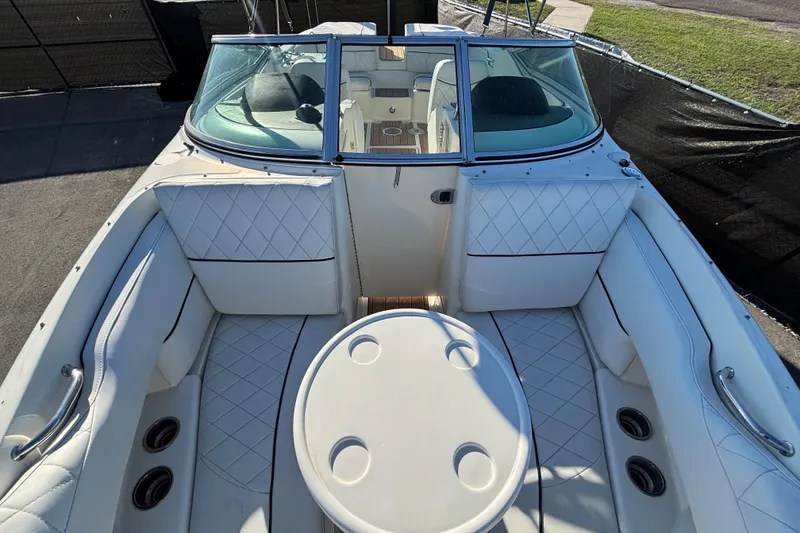 Slide: The Image of 2007 Sea Ray SLX 250 boat interior with white seating and teak flooring. - 26