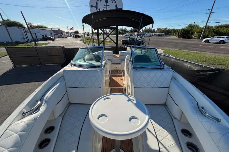 Slide: The Image of 2007 Sea Ray SLX 250 boat interior with white seating and wood accents. - 27