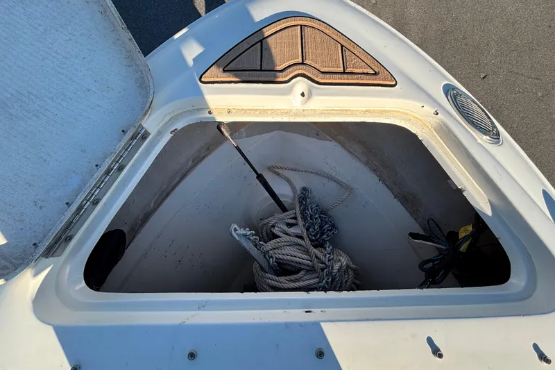 Slide: The Image of 2007 Sea Ray SLX 250 boat interior with cushioned seating and teak flooring. - 29