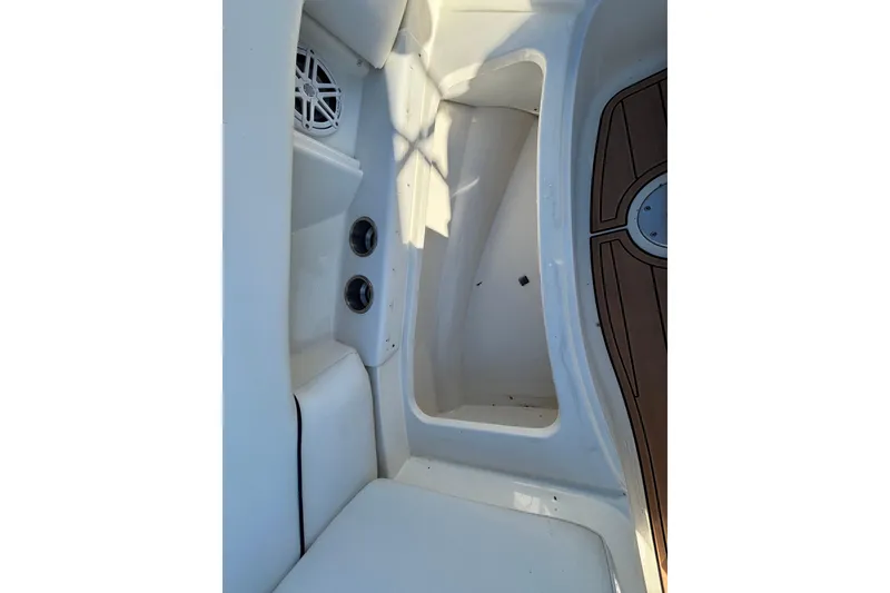 Slide: The Image of 2007 Sea Ray SLX 250 boat interior with seating, sink, and teak flooring. - 32