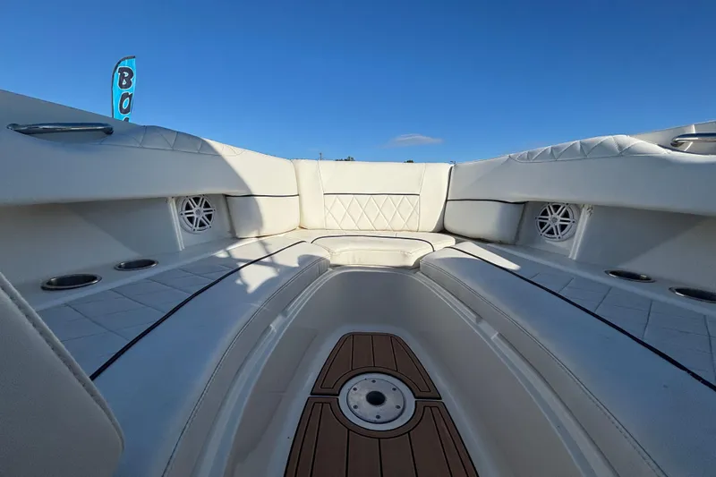 Slide: The Image of 2007 Sea Ray SLX 250 boat interior with open storage compartment and cushioned seating. - 37