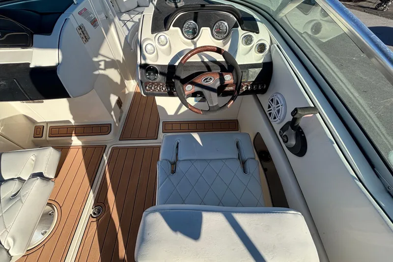 Slide: The Image of Storage compartment of a 2007 Sea Ray SLX 250 boat with a yellow paddle. - 48