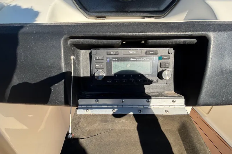 Slide: The Image of 2007 Sea Ray SLX 250 boat interior with white seating and wood accents. - 53