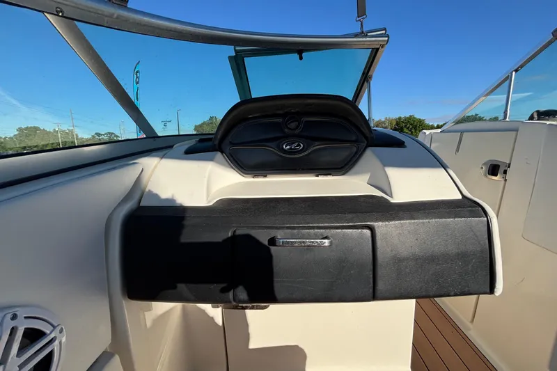 Slide: The Image of 2007 Sea Ray SLX 250 boat interior with white seating and round table. - 54