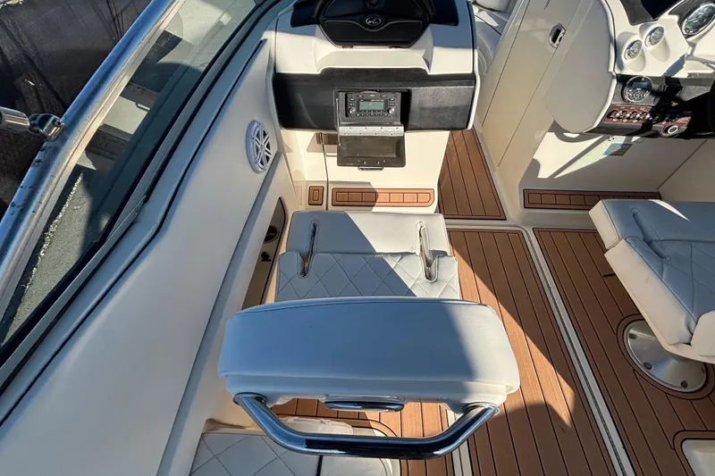 Slide: The Image of Interior view of a 2007 Sea Ray SLX 250 boat, featuring seating and storage. - 56