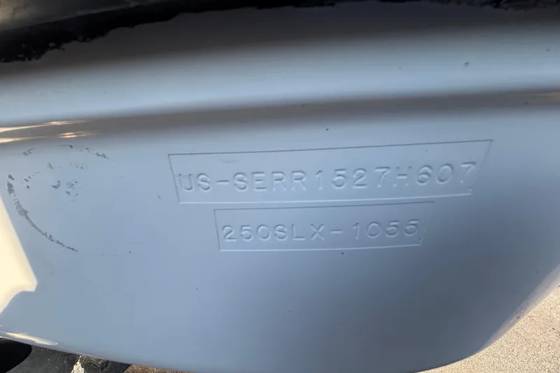 Slide: The Image of 2007 Sea Ray SLX 250 boat on trailer, parked outdoors under clear blue sky. - 6