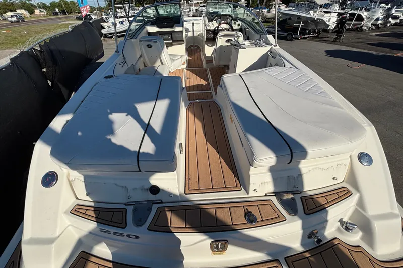 Slide: The Image of 2007 Sea Ray SLX 250 boat interior with white cushioned seating and speaker. - 61