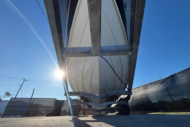 Slide: The Image of Trailer wheels for a 2007 Sea Ray SLX 250 boat on asphalt. - 64