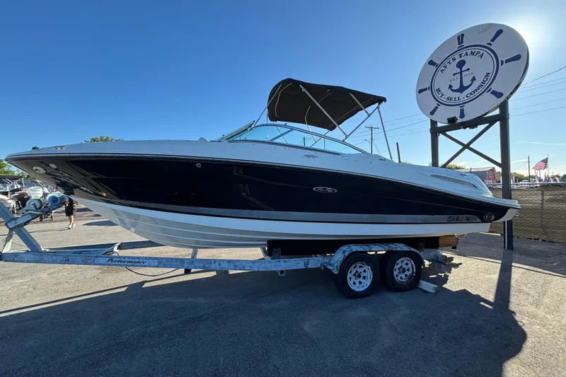 Slide: The Image of 2007 Sea Ray SLX 250 boat interior with white seating and wood flooring. - 67