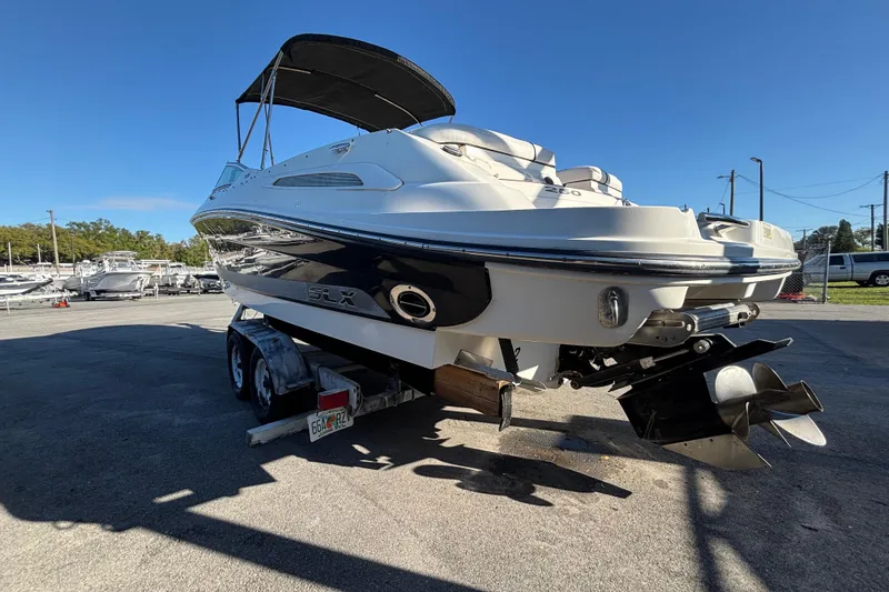Slide: The Image of 2007 Sea Ray SLX 250 boat interior with white seating and storage compartment. - 68