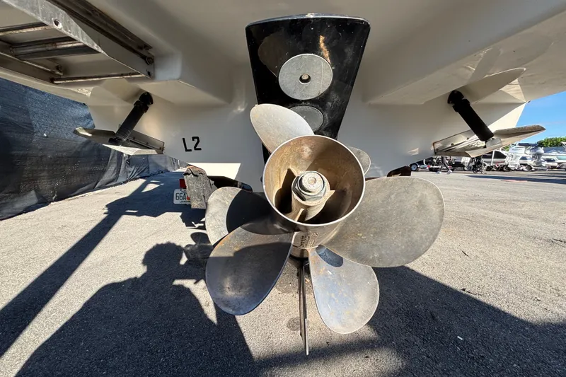 Slide: The Image of 2007 Sea Ray SLX 250 boat interior with white seating and table, docked outdoors. - 69