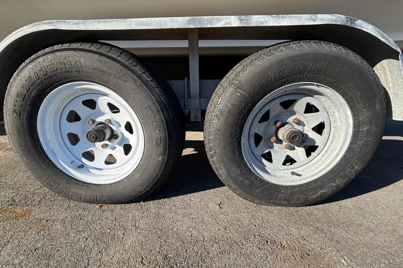 Slide: The Image of 2007 Sea Ray SLX 250 boat on trailer at dealership under clear blue sky. - 7