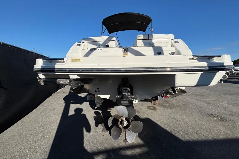 Slide: The Image of 2007 Sea Ray SLX 250 boat interior with white seating and open deck layout. - 71