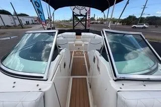 Slide: The Image of 2007 Sea Ray SLX 250 boat with open deck and seating, displayed outdoors. - 74