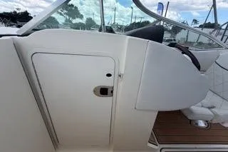Slide: The Image of 2007 Sea Ray SLX 250 boat interior with white seating and wooden flooring. - 75