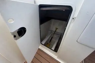 Slide: The Image of Storage compartment on 2007 Sea Ray SLX 250 boat, open door revealing interior space. - 76