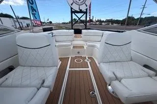 Slide: The Image of 2007 Sea Ray SLX 250 boat interior with white seating and teak flooring. - 80