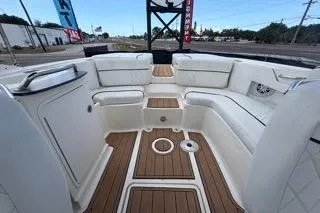 Slide: The Image of 2007 Sea Ray SLX 250 boat interior with white seating and teak flooring. - 81