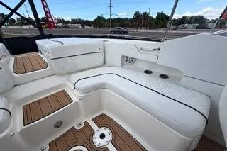 Slide: The Image of 2007 Sea Ray SLX 250 boat interior with white seating and wood accents. - 83