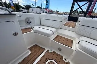 Slide: The Image of 2007 Sea Ray SLX 250 boat interior with white seating and teak flooring. - 86