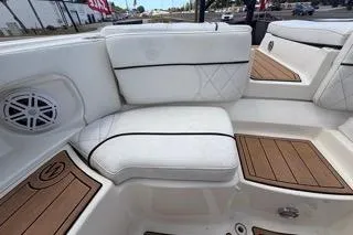 Slide: The Image of 2007 Sea Ray SLX 250 boat interior with white seating and teak flooring. - 87
