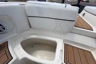 Slide: The Image of 2007 Sea Ray SLX 250 boat interior with white seating and wood accents. - 88