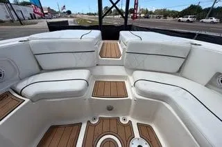 Slide: The Image of 2007 Sea Ray SLX 250 boat interior with white seating and wooden flooring. - 89