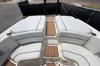 Slide: The Image of 2007 Sea Ray SLX 250 boat interior with white seating and wood accents. - 90