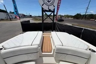 Slide: The Image of 2007 Sea Ray SLX 250 boat interior with white seating and wooden deck. - 91