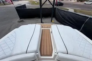 Slide: The Image of 2007 Sea Ray SLX 250 boat with white seating and wooden deck. - 94
