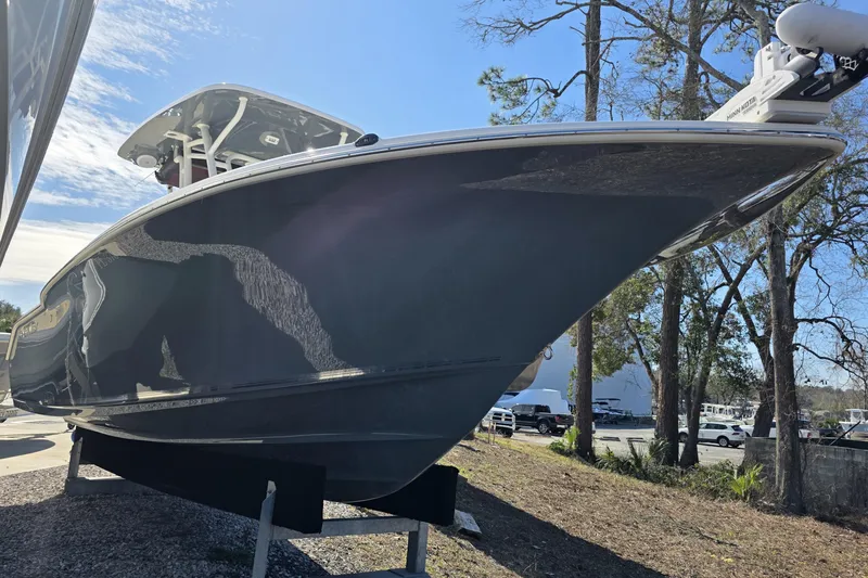 Slide: The Image of 2021 Key West 244 Center Console boat displayed outdoors on a sunny day. - 2
