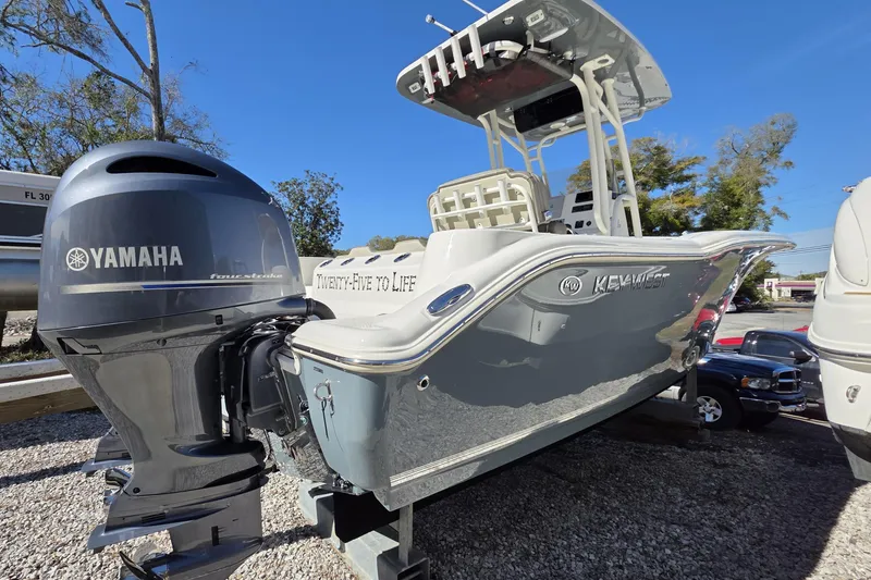 Slide: The Image of 2021 Key West 244 Center Console boat with Yamaha engine, parked outdoors. - 3