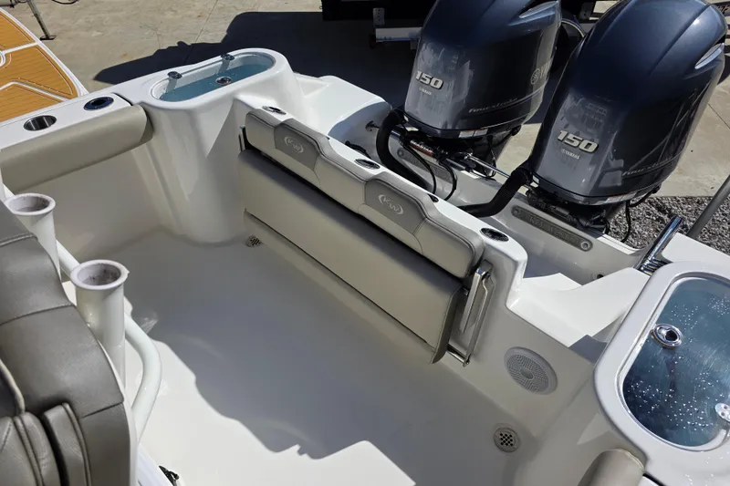 Slide: The Image of 2021 Key West 244 Center Console boat with dual Yamaha 150 engines and seating area. - 8