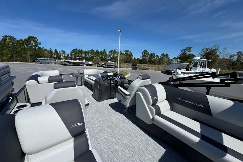 Slide: The Image of 2026 Bennington 22 SSR pontoon boat interior with plush seating and modern dashboard. - 12