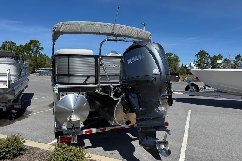 Slide: The Image of 2026 Bennington 22 SSR pontoon boat with Yamaha outboard motor in parking lot. - 4