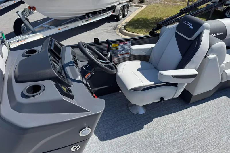 Slide: The Image of 2026 Bennington 22 SSR boat interior with steering console and captain's chair. - 9