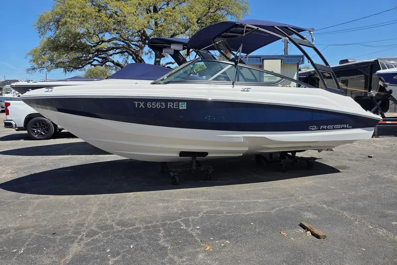 The Image of 2022 Regal 2000 ES Bowrider boat on display in a parking lot. - 1