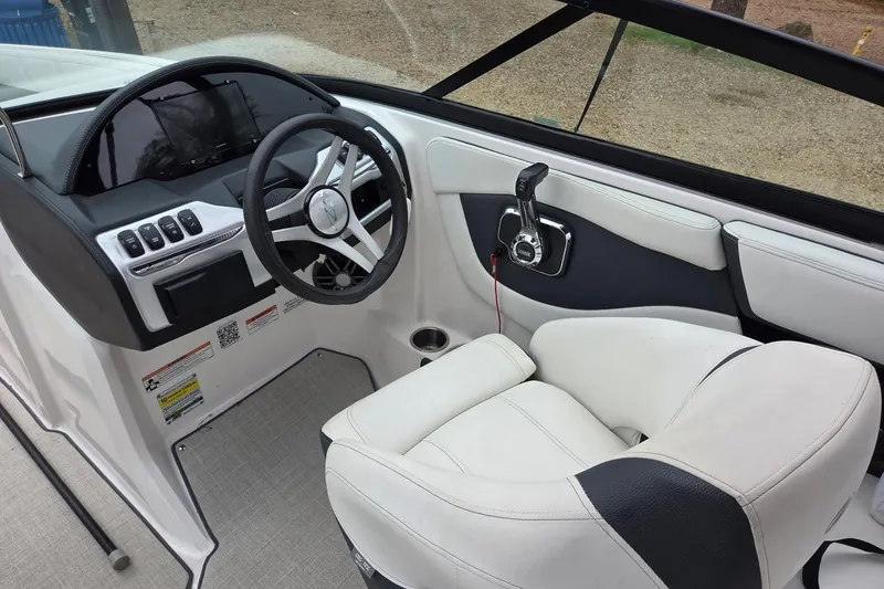 Slide: The Image of 2022 Regal 2000 ES Bowrider cockpit with steering wheel and control panel. - 4