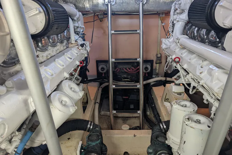 Slide: The Image of Engine room of a 1998 Little Harbor WhisperJet 55 yacht, featuring dual engines and a central ladder. - 10