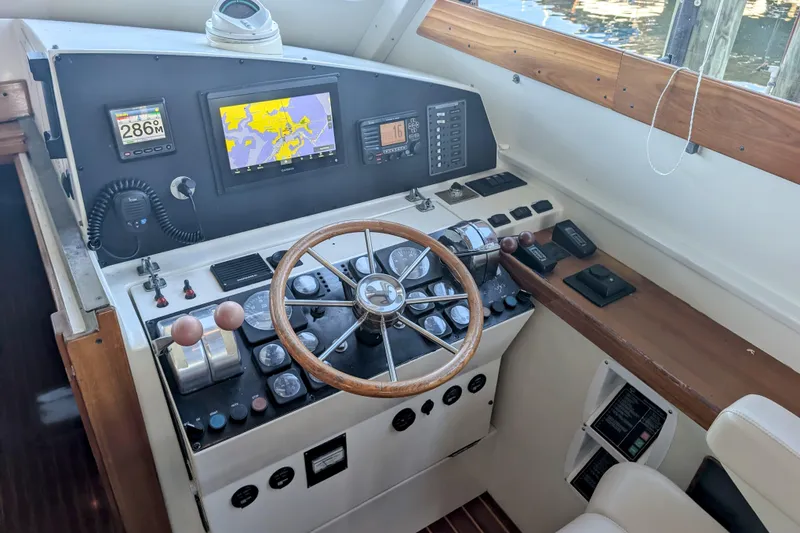 Slide: The Image of Control panel of 1998 Little Harbor WhisperJet 55 with navigation screens and steering wheel. - 13