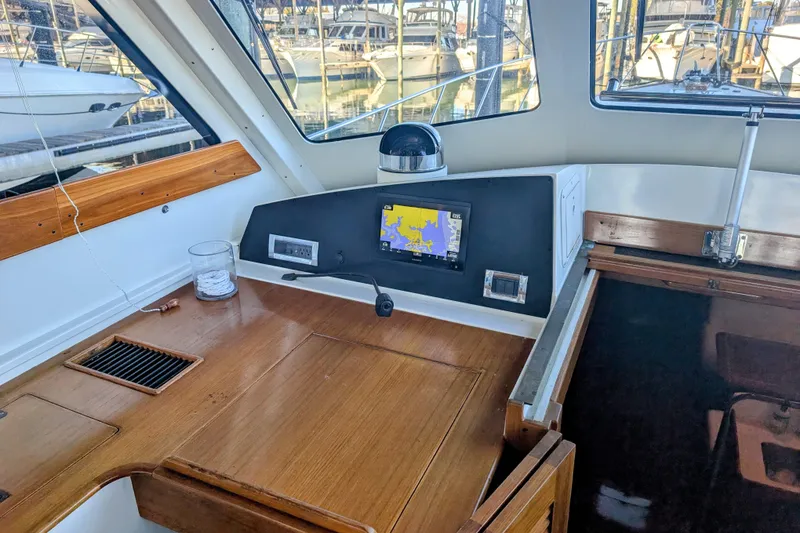 Slide: The Image of Interior helm of 1998 Little Harbor WhisperJet 55 with navigation equipment and wooden finish. - 14