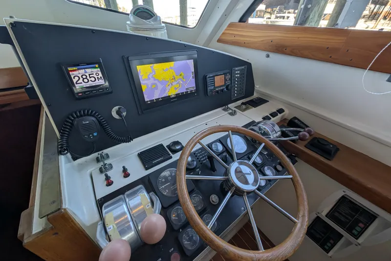 Slide: The Image of Cockpit of 1998 Little Harbor WhisperJet 55 with navigation instruments and wooden steering wheel. - 23