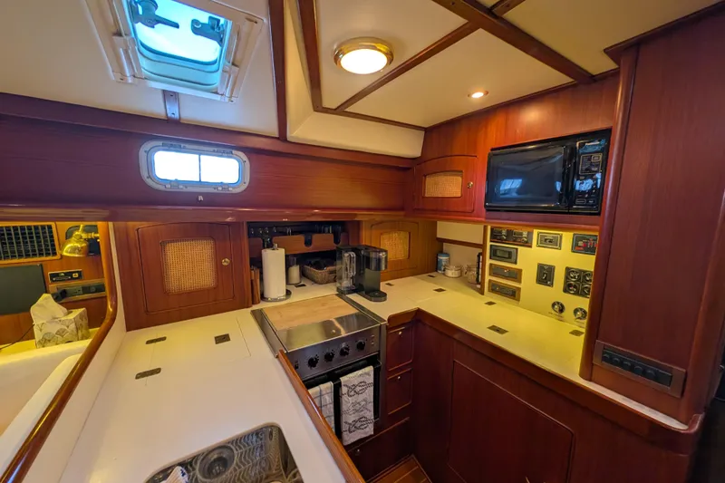 Slide: The Image of Luxurious 1998 Little Harbor WhisperJet 55 yacht kitchen with wood cabinetry and modern appliances. - 26