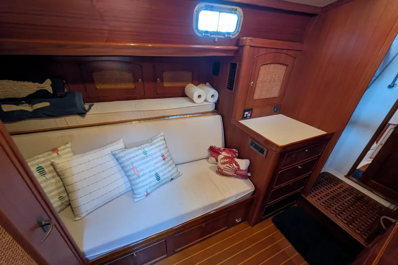 Slide: The Image of Cozy cabin interior of 1998 Little Harbor WhisperJet 55 with cushions and wooden cabinetry. - 28