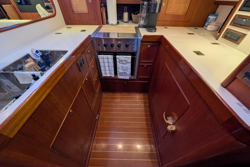 Slide: The Image of Galley kitchen in 1998 Little Harbor WhisperJet 55 yacht with wooden cabinetry and modern appliances. - 29