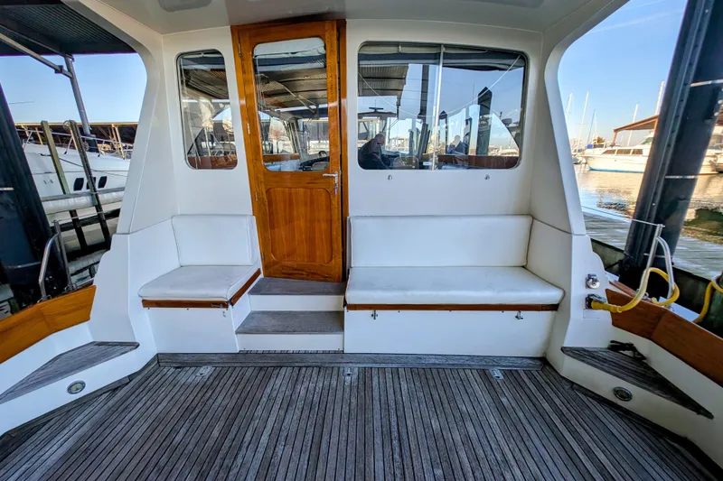 Slide: The Image of 1998 Little Harbor WhisperJet 55 yacht interior with wooden door and cushioned seating. - 4