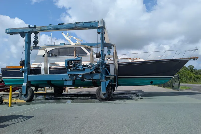 Slide: The Image of 1998 Little Harbor WhisperJet 55 yacht on a boat lift under a cloudy sky. - 44